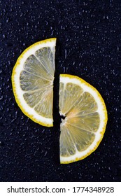 Thin slice of lemon with a black background.