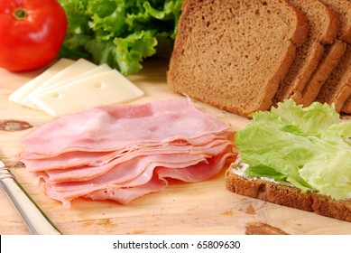 Thin Sliced Deli Ham Being Made Into A Sandwich