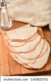 Thin Sliced Turkey Breast Meat On A Cutting Board, High Angle View