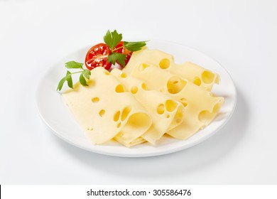 Thin Slices Of Emmental Cheese On White Plate