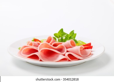 Thin Slices Of Ham On White Plate