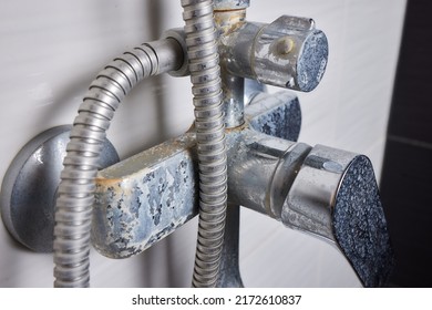 A Thin Stream Of Hard Water Flows From An Old Tap Aerator. Old Bathroom Sink Faucet Contaminated With Calcium And Grime.