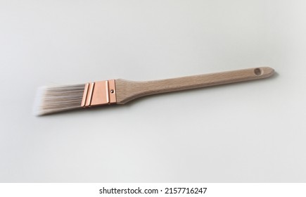 A Thin Trim Paint Brush With A Copper Ferrule