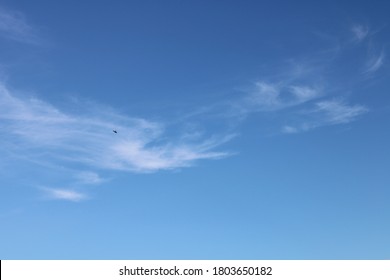 thin wispy clouds in perfect clear blue summer sky background