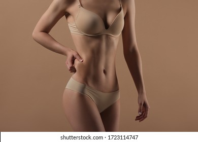 Thin Woman Shows Fold Of Fat. Fitness, Weight Loss And Body Care