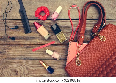 Things From Open Lady Handbag. Women's Purse On Wood Background. Toned Image. 