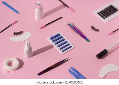 Things For The Work Of Lash-makers, Artificial Eyelashes, Microbrachis, Glue, Tweezers, Combs, Brushes For Eyelash Extensions. Eyelash Extension, Painting Of Eyebrows. Pink Background.