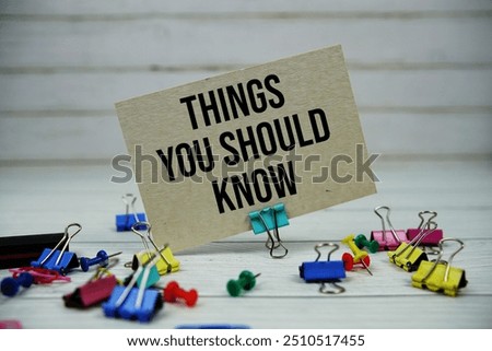 Things You Should Know text on paper card with stationary on wooden background