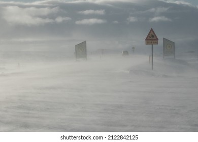 Thingvellir National Park Iceland February 4 2022 Snow Storm And Windy Weather, Cars Driving On The Road In Bad Visibility And Strong Wind Alert, Traffic Signs