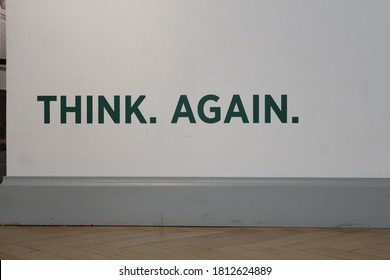 A Think Again Sign Painted On A White Background