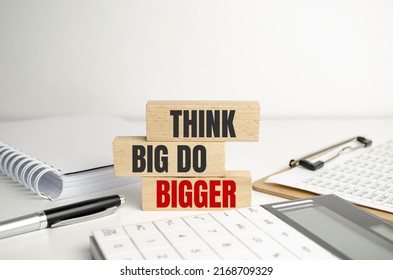 Think Big, Do Bigger Motivation Quote . Text On Wooden Cubes