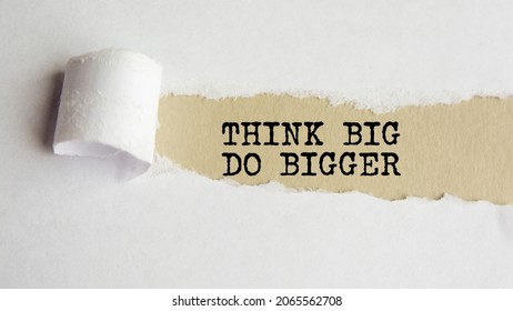 Think Big Do Bigger. Words. Text On Grey Paper On Torn Paper Background.