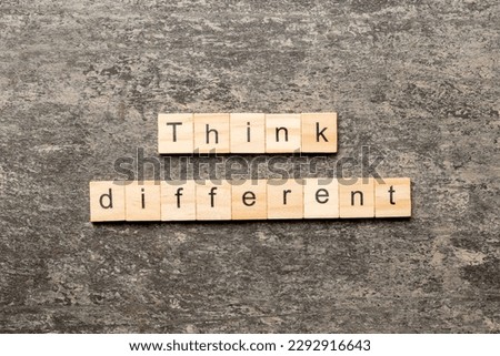 think different word written on wood block. think different text on table, concept.