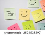 Think Positive and smile emoticon on sticky notes. Motivational words for personal development, inspirational handwriting. Isolated on background
