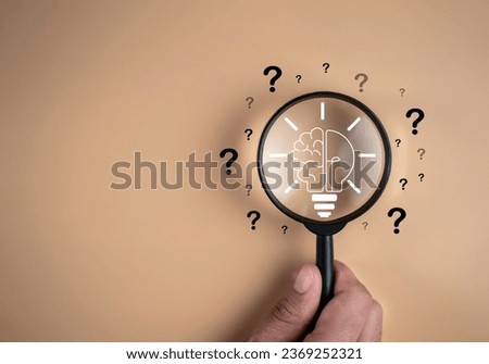 Think smart idea with problem solution concept. Magnifying glass focus on light bulb with question mark Creative inspiration thinking idea and problem solving motivation for success.