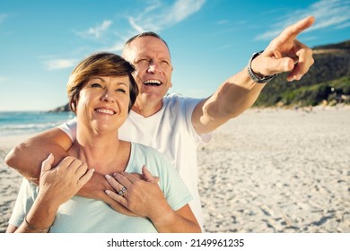 I Think That House Would Be Perfect For Us. Shot Of A Mature Couple Spending The Day At The Beach.