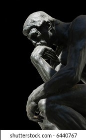 The Thinker, famous statue by Auguste Rodin, isolated on black