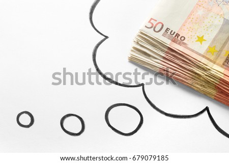 Thinking about money. Dreaming of rich and wealthy life. Money on mind. Lucrative new business idea. Hand drawn thinking speech bubble and thought cloud and a stack of 50 euro bills.