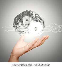 Thinking about structuring virtual diagram of business process with solutions. businessman hand showing 3d metal human brain as concept