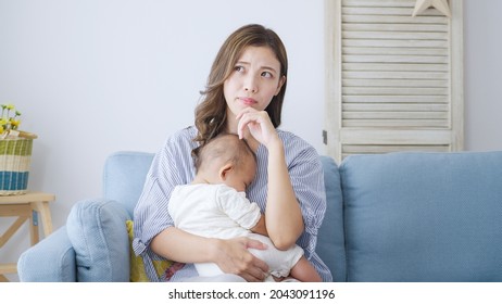 Thinking Asian Mom And Baby At Home