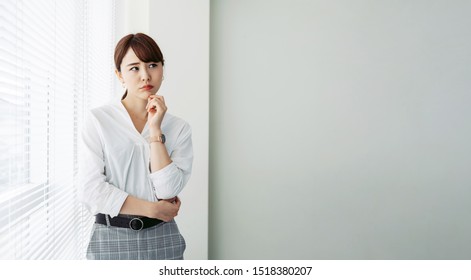 Thinking Asian Woman In Office.,