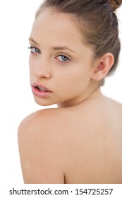 Thinking brunette model posing looking over her shoulder on white background