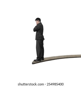 Thinking businessman standing on springboard with white background