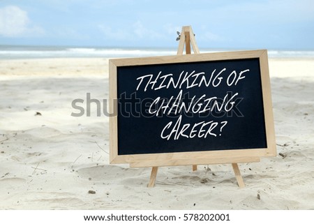 THINKING OF CHANGING CAREER? Chalkboard with written message and beautiful beach background.