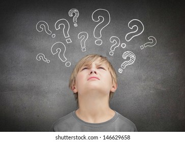 Thinking Child Looking At Question Marks Above His Head