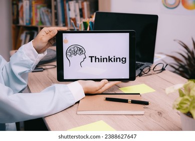 Thinking concept:  tablet presentation of keywords on the table for creative work or business