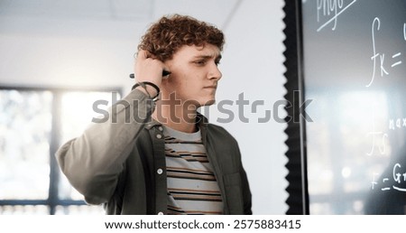Thinking, confused and math with man in classroom for formula solution, education and problem solving. Science, doubt and equation with person in college for learning, study and physics course