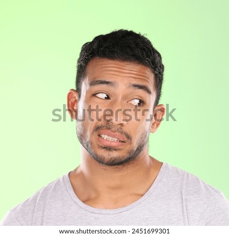 Thinking, crazy and face of man with doubt in studio on pastel green background with awkward feedback. Confused, question and embarrassed person with puzzle, challenge or conflict in mock up space