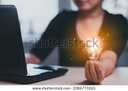 thinking and creative concept, Close up the light bulb and woman working on the desk, Creativity, and innovation are keys to success,  new idea and innovation with Brain and light bulbs,