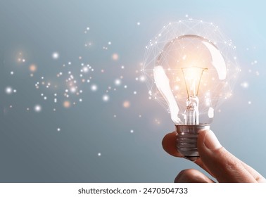 thinking and creative light bulb in human hands