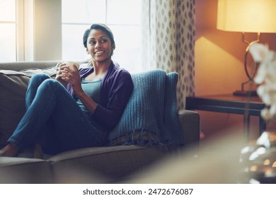 Thinking, drinking coffee and smile of Indian woman in home living room for morning cup of latte or espresso to relax. Tea, dream or person on sofa for peace, calm or planning future in apartment - Powered by Shutterstock