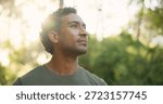 Thinking, explore or man in forest with hiking, fresh air or contemplation on trekking journey. Reflection, bokeh or person in nature with thoughts, mindfulness or daydreaming in outdoor adventure.