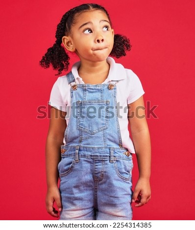 Thinking, girl and red studio background of an isolated young child with an idea and casual fashion. Relax, youth ideas and calm child feeling curious alone with denim dungarees of cute kid