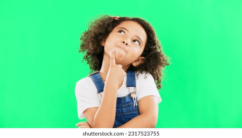 Thinking, green screen and a child with a decision isolated on a studio background. Doubt, think and a confused girl kid looking thoughtful, contemplating and planning an idea with mockup space