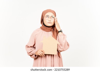 Thinking And Holding Cutout House Of Beautiful Asian Woman Wearing Hijab Isolated On White Background