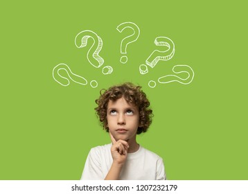 Thinking Kid - 6 Years Old Child Thinking And Asking Himself A Question. Isolated On Green Background And Question Mark Over His Head