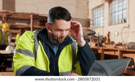 Thinking, laptop and man in workshop for construction contract, material supplier and carpentry. Thoughtful, computer and person with inventory list, timber stock and planning for infrastructure