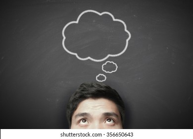 Thinking man with thinking bubble on blackboard background. - Shutterstock ID 356650643