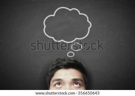 Thinking man with thinking bubble on blackboard background.