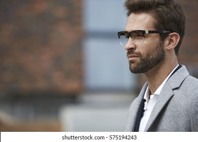 Thinking Man In Glasses And Coat