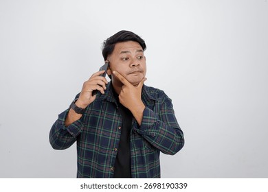 Thinking Man Holding Smartphone While Making Decision