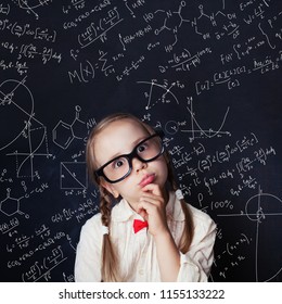 Thinking mathematics student on school blackboard background with chalk hand drawings science formula pattern. Kids mathematics education concept. - Shutterstock ID 1155133222