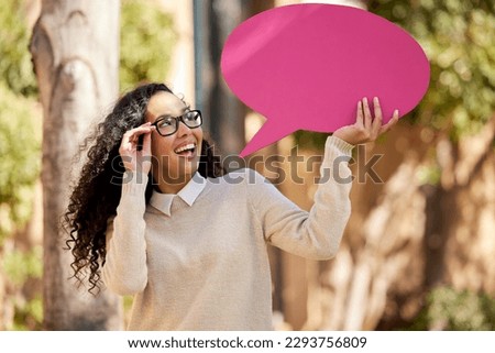 Thinking myself into a brighter future. Shot of a beautiful young student holding a speech bubble above her head while standing outside.