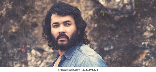 Thinking powerful man with full beard outdoor in urban style