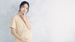 Young pregnant woman in white underwear in the bathroom checks her