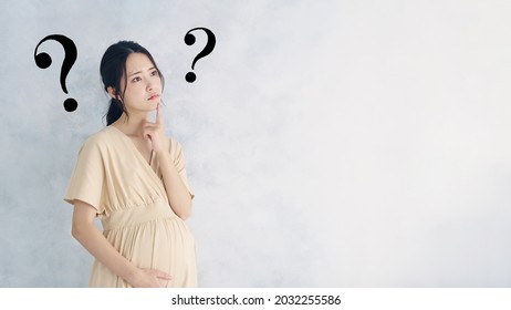 Thinking Pregnant Asian Woman Concept. Maternity Melancholy.